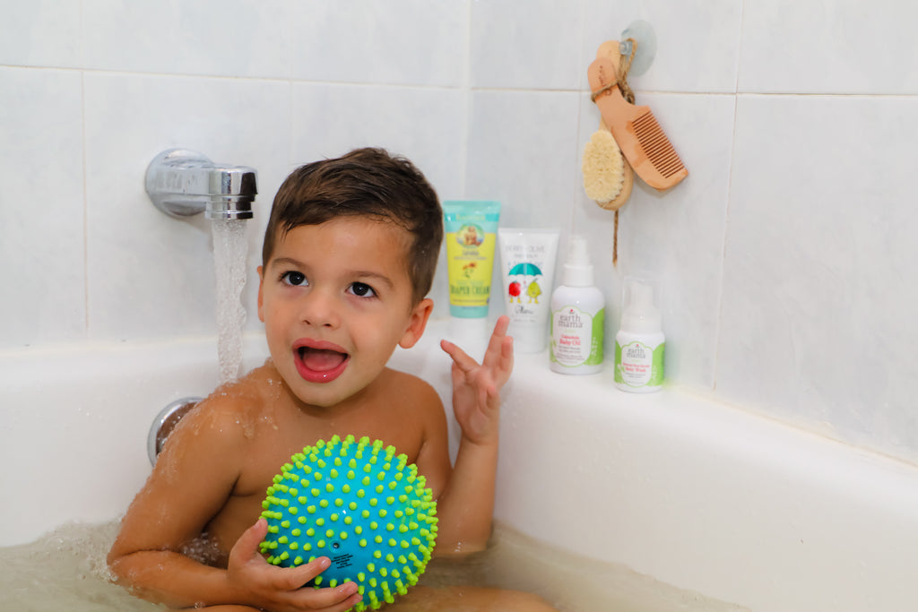 baby boy washing in bathtub